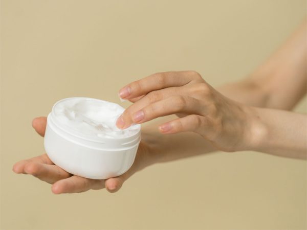 Person holding personal care product